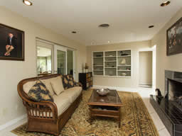 The family room has a fireplace and built-in display shelving