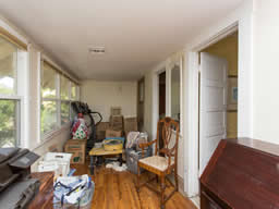 This enclosed sleeping porch is accessed through two second floor bedrooms
