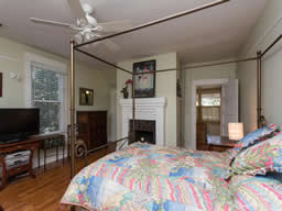 This bedroom features a fireplace and a dressing room