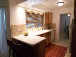 The remodeled kitchen has a dining bar