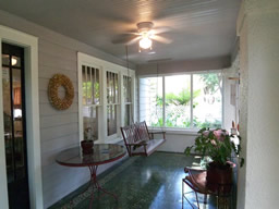 The porch has original Cuban tile and a cozy swing.