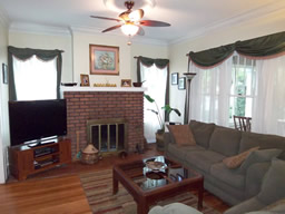 Notice the dramatic crown moldings and a wood-burning fireplace.