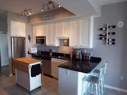 Stainless steel appliances complement the granite countertops