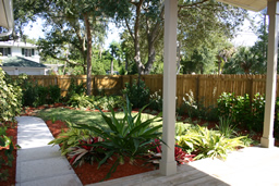 A lush rear yard is fully fenced.