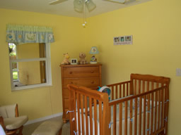 This bedroom, currently the nursery, is bright and airy as well
