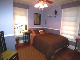 This corner bedroom has lots of light.