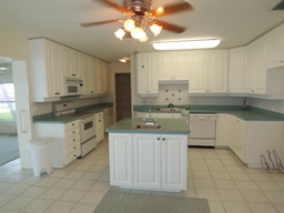 The large kitchen has a central island and super walk-in pantry.