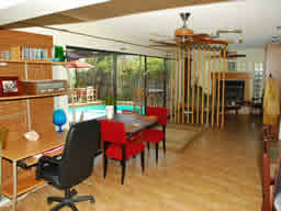 This versatile Florida room has a fireplace.