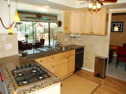 The remodeled kitchen has a view out to the pool.
