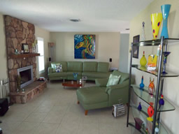 The living room focuses a wood-burning fireplace