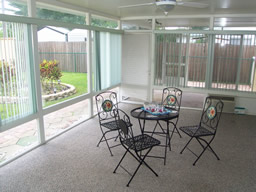 The glassed-in Florida room has its own wall air conditioner.