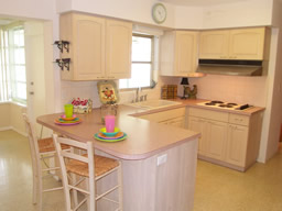 The island kitchen has newer cabinets and some newer appliances.