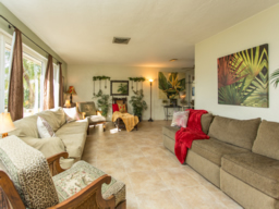 A spacious formal living room has great light from west windows.