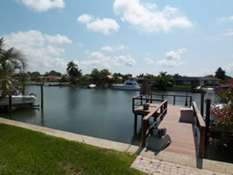 The dock and boat lift on a wide canal
