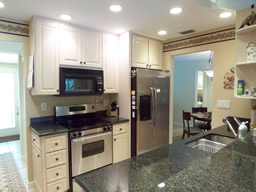 An updated kitchen with granite counters.