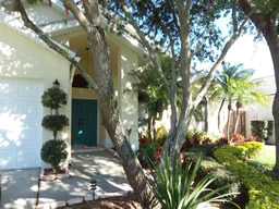 Lush tropical foliage leads to the front door