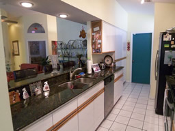 The kitchen is galley style with lots of cabinetry