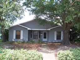 This cute home is set among shady, mature trees.