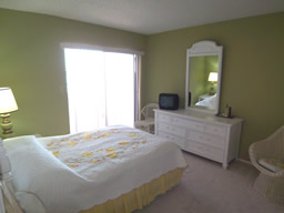  This bedroom has sliding glass doors out to the balcony.