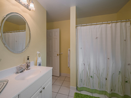 The cheery hall bath is quite large.