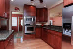 Handsome cherry cabinetry, granite counters, lots of space.