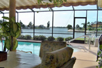 The lanai and pool deck both overlook the wide waterfront